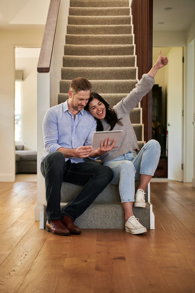 Happy couple reviewing mortgage options at home