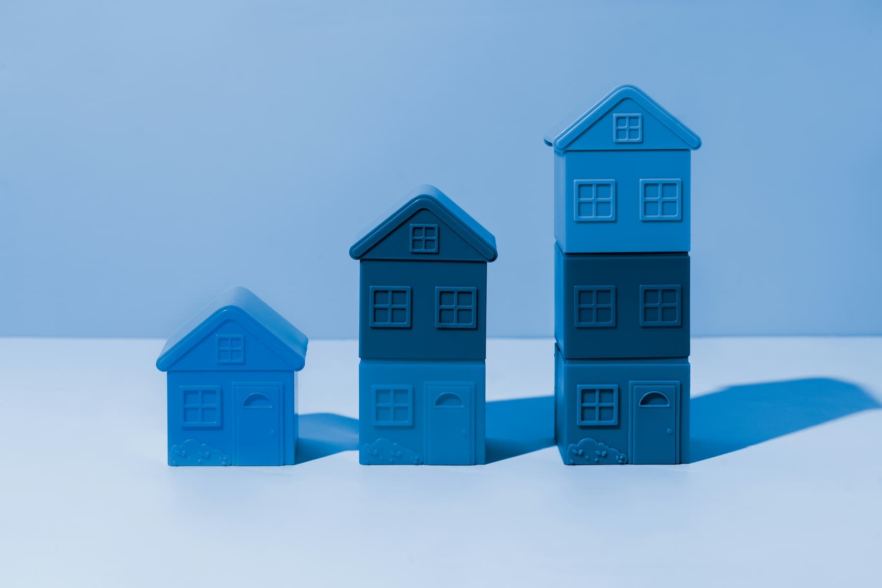 Stacked model houses representing a property portfolio